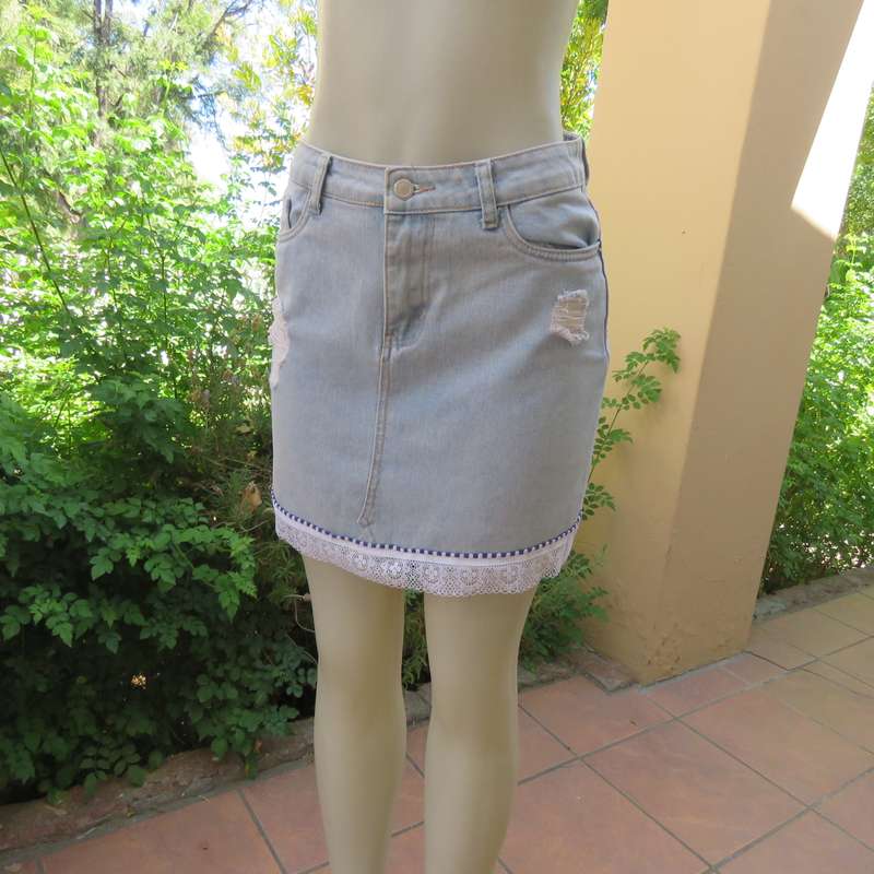 Sexy light blue denim jean distressed look  skirt. Pencil style. Decorative hem. Size 32. As new con