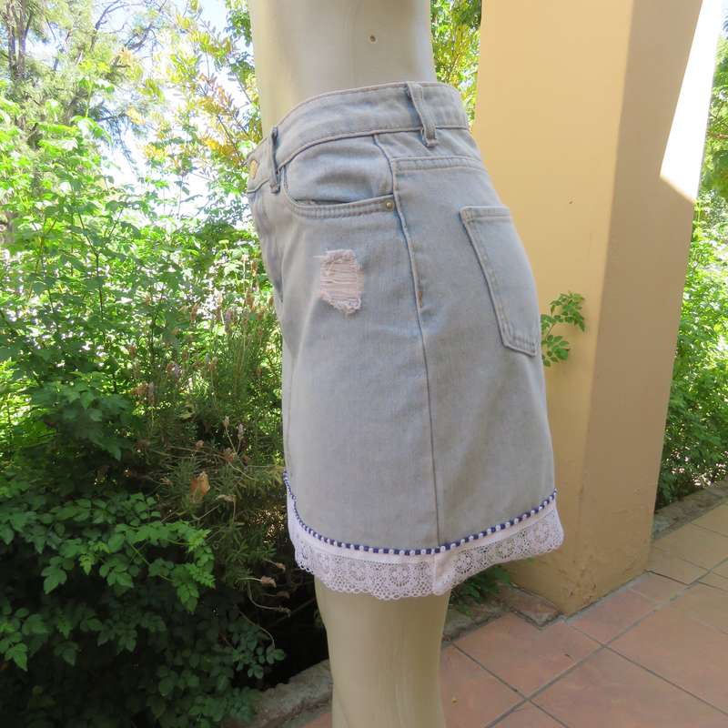 Sexy light blue denim jean distressed look  skirt. Pencil style. Decorative hem. Size 32. As new con