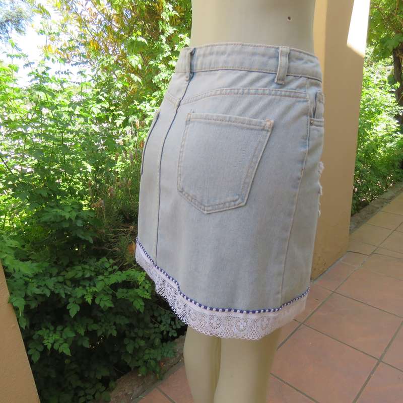 Sexy light blue denim jean distressed look  skirt. Pencil style. Decorative hem. Size 32. As new con