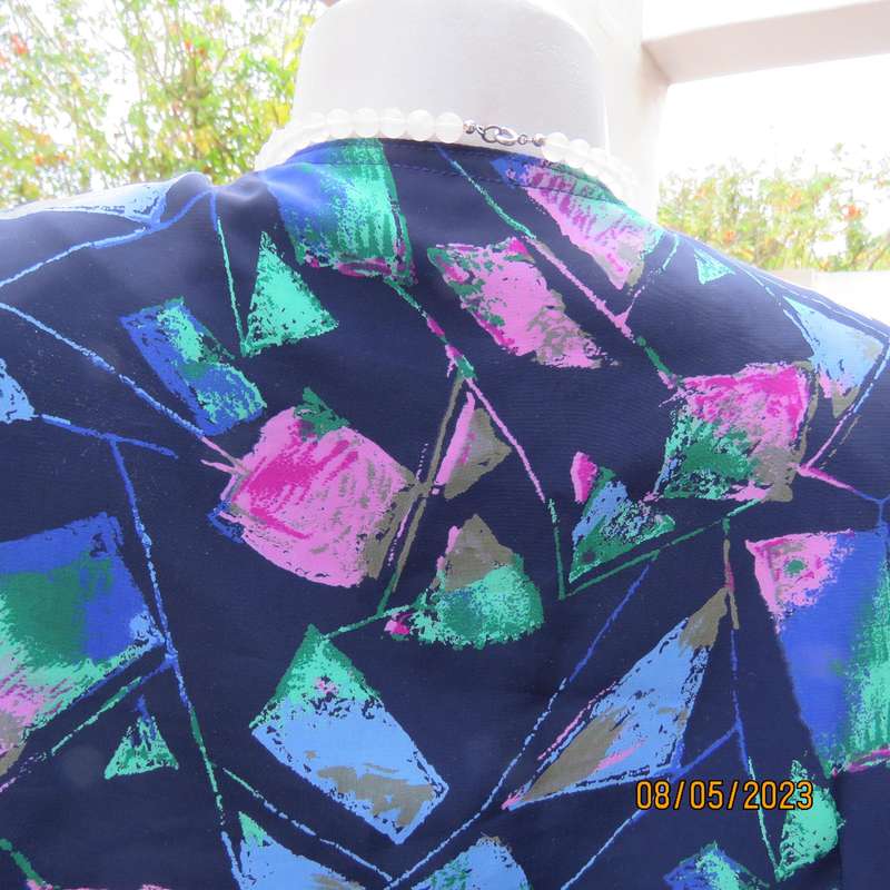 Boutique made navy silky polyester top-short sleeve jacket. Colourful print. Size 40