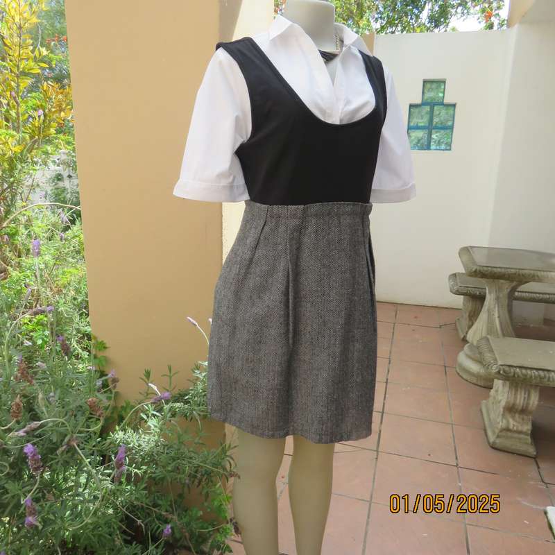 Unique pinafore with black stretch polyester top/black and white striped woolen bottom.Size 36.