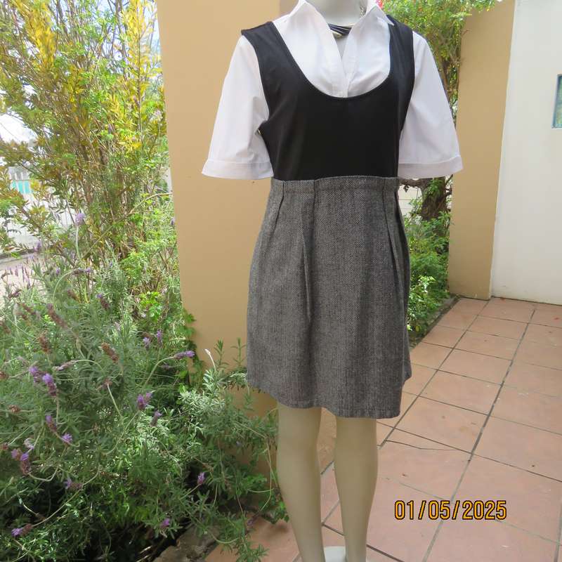 Unique pinafore with black stretch polyester top/black and white striped woolen bottom.Size 36.