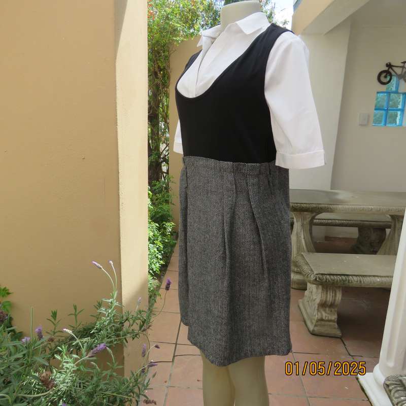 Unique pinafore with black stretch polyester top/black and white striped woolen bottom.Size 36.