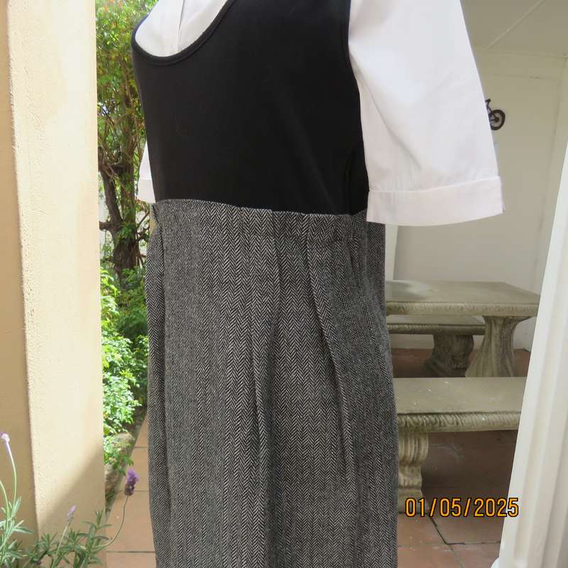 Unique pinafore with black stretch polyester top/black and white striped woolen bottom.Size 36.