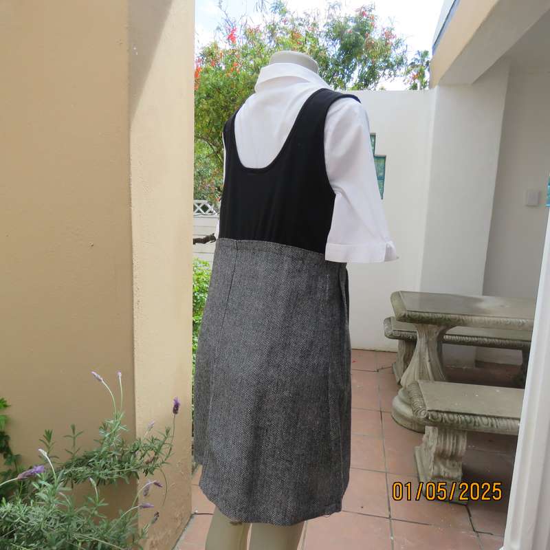 Unique pinafore with black stretch polyester top/black and white striped woolen bottom.Size 36.