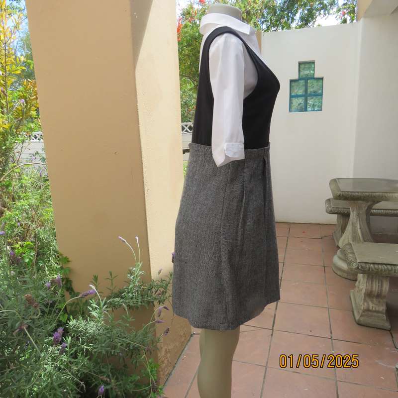 Unique pinafore with black stretch polyester top/black and white striped woolen bottom.Size 36.