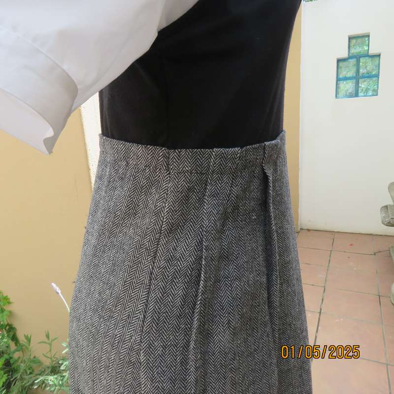 Unique pinafore with black stretch polyester top/black and white striped woolen bottom.Size 36.