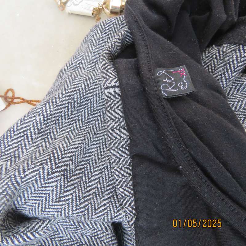 Unique pinafore with black stretch polyester top/black and white striped woolen bottom.Size 36.
