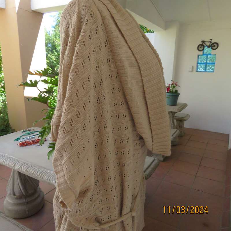 Beige 100% acrylic knit top in lace stitch. Wide open collar. Size 54.