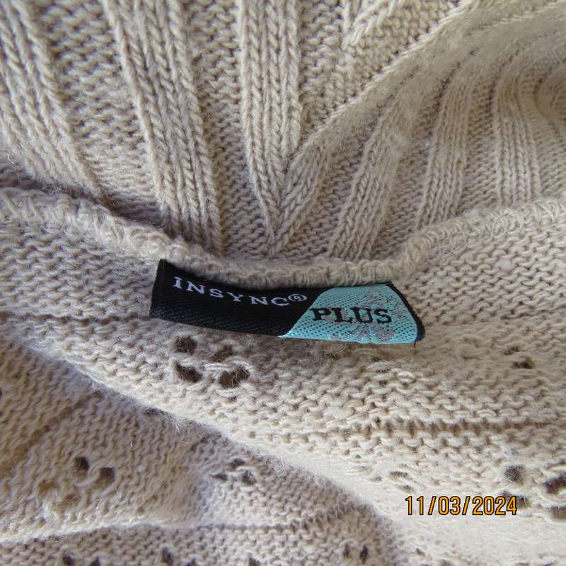 Beige 100% acrylic knit top in lace stitch. Wide open collar. Size 54.