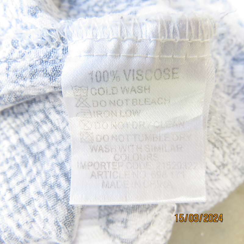 Cute white-navy crinkled viscose peasant style top. Size 38. Frilled hemline.