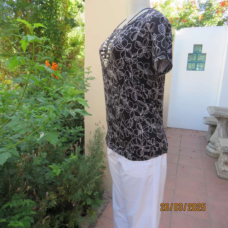 REAL basic black soft stretch polyester top with white lilies. Cut-on short sleeves. Size 36