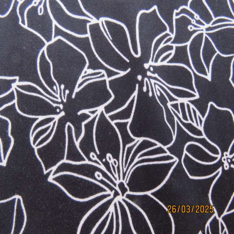 REAL basic black soft stretch polyester top with white lilies. Cut-on short sleeves. Size 36