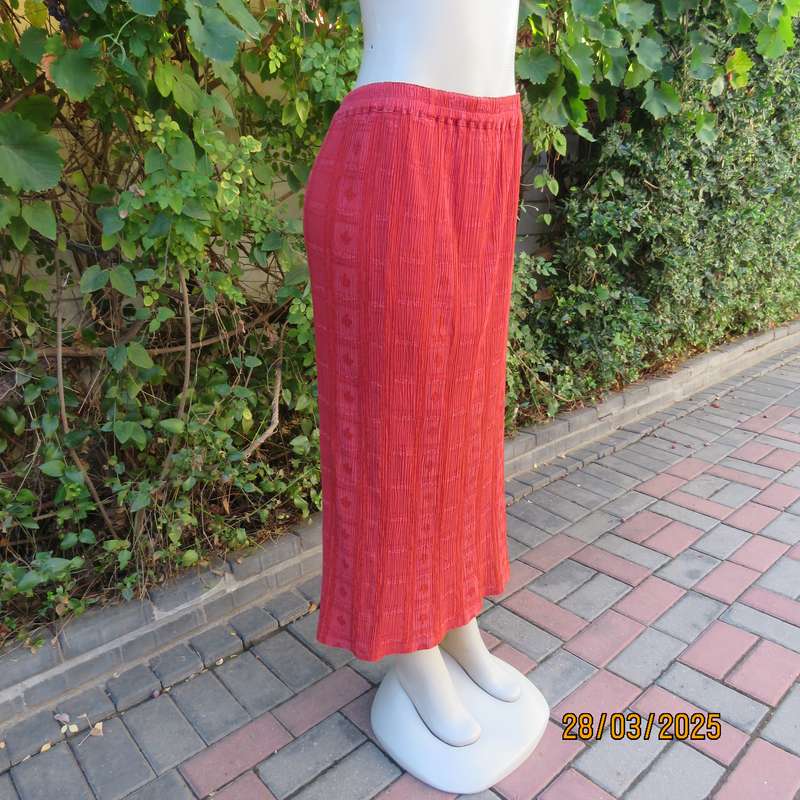 Burnt orange colour ankle length crinkled polycotton size 36 skirt with  embossed patterns.