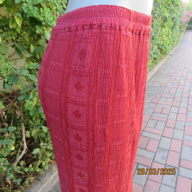 Burnt orange colour ankle length crinkled polycotton size 36 skirt with  embossed patterns.