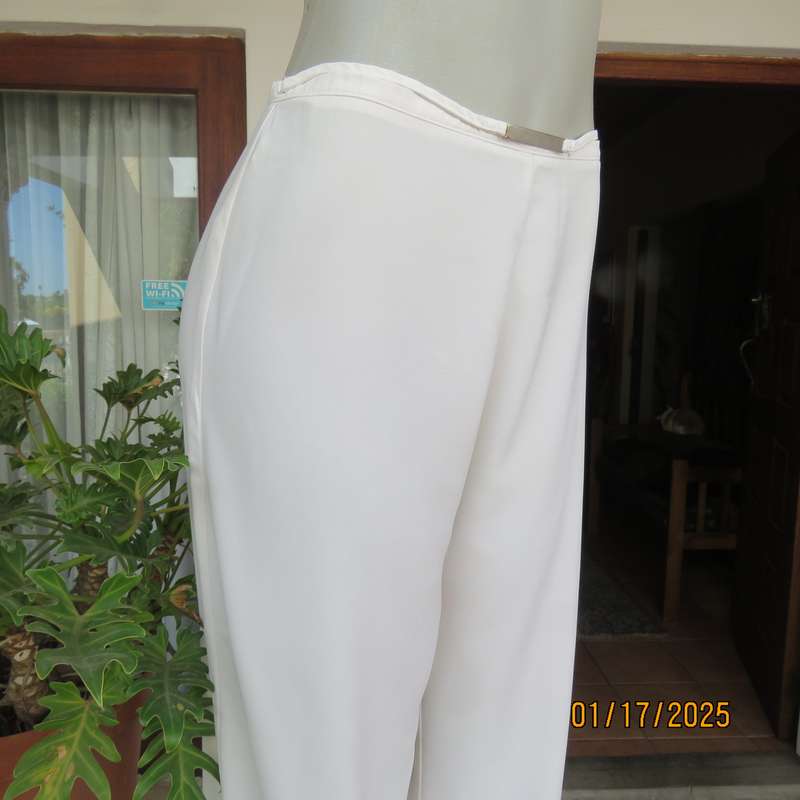 Amazing light cream dress pants with straight legs size 34. Narrow waistband. Zip at back. As new