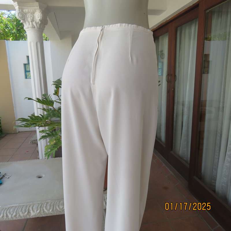Amazing light cream dress pants with straight legs size 34. Narrow waistband. Zip at back. As new