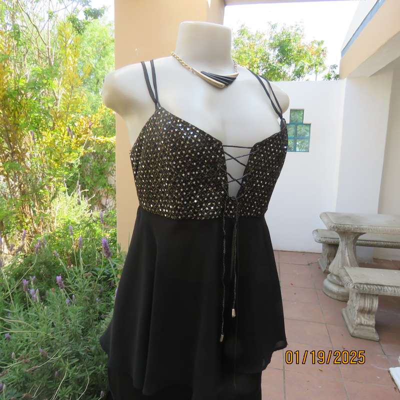 Sexy black polyester evening top with sequined bodice.Empire style. Size 34.Shoulder straps.As new