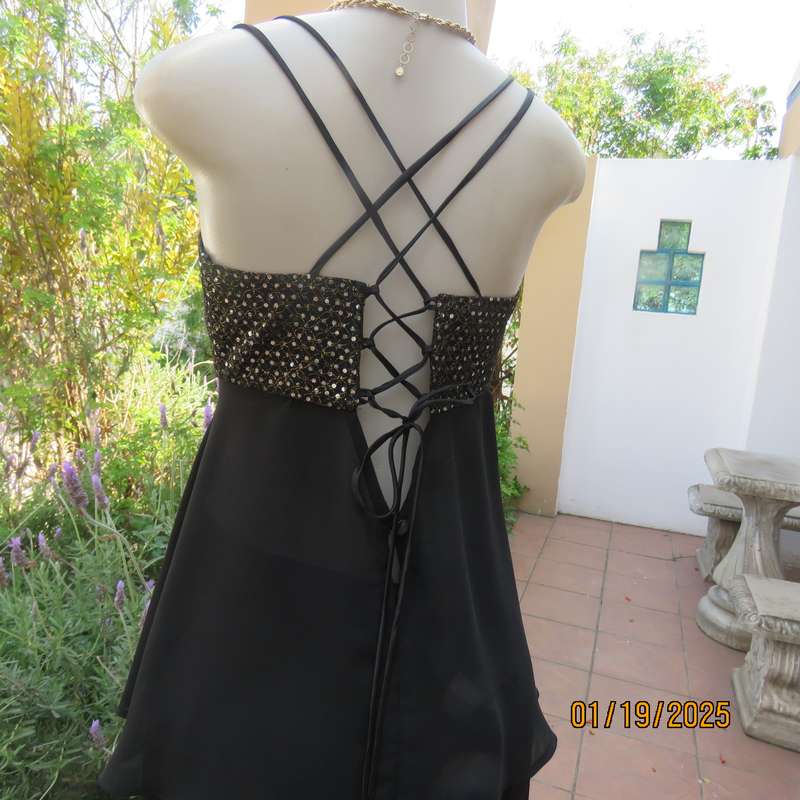 Sexy black polyester evening top with sequined bodice.Empire style. Size 34.Shoulder straps.As new