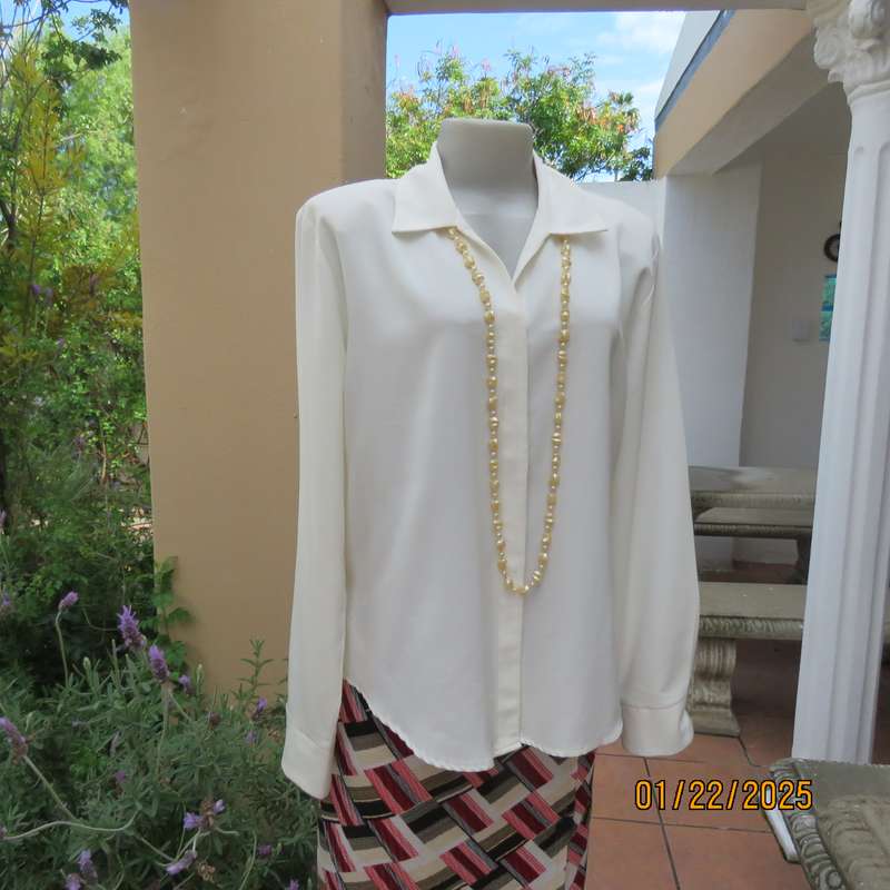 Smart light cream long cuffed sleeve polyester top size 38-40. Hidden button down.Open collar.As new