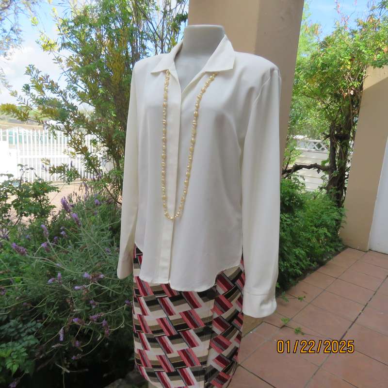 Smart light cream long cuffed sleeve polyester top size 38-40. Hidden button down.Open collar.As new