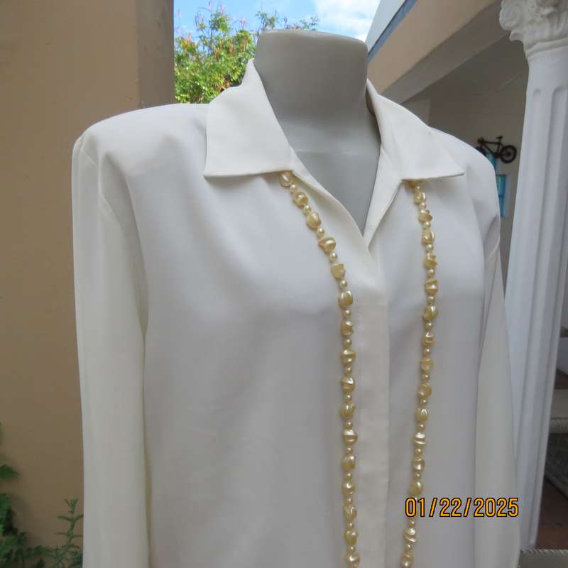 Smart light cream long cuffed sleeve polyester top size 38-40. Hidden button down.Open collar.As new