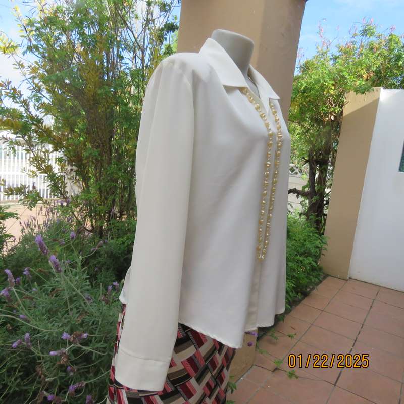 Smart light cream long cuffed sleeve polyester top size 38-40. Hidden button down.Open collar.As new