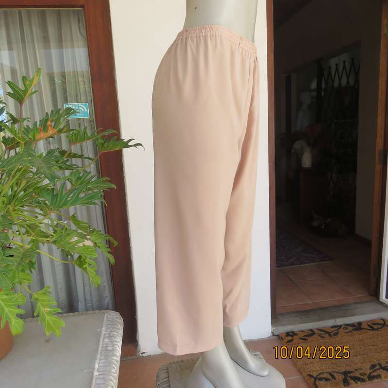 Rich cream silky polyester ankle length pants with elasticated waist. Size 40.