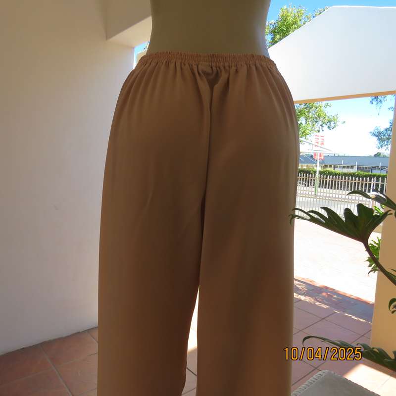 Rich cream silky polyester ankle length pants with elasticated waist. Size 40.