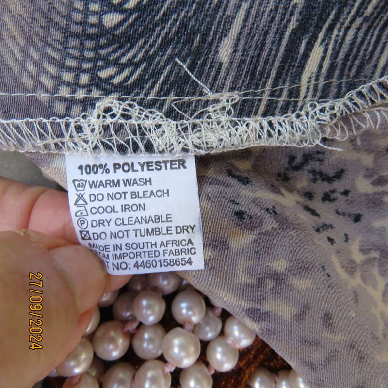 As new PRINCESS DI animal print short sleeve top. Peach accents.Size 38. Open collar.Polyester.