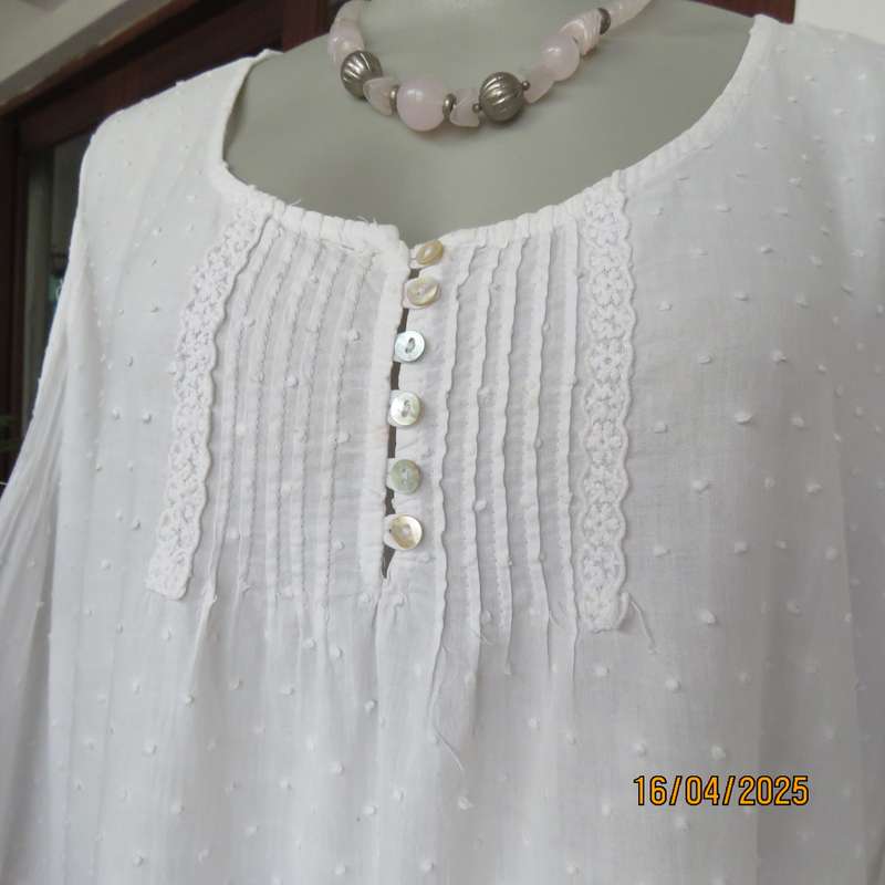 White swiss dot cotton slip over size 42 top with elbow length sleeves.
