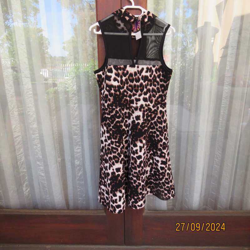 Pretty animal print textured stretch polyester dress with sheer black top area. Girl 9 to 10 years.