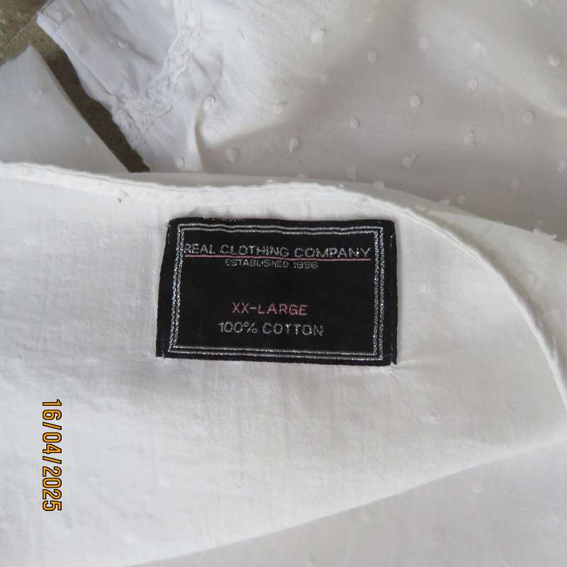White swiss dot cotton slip over size 42 top with elbow length sleeves.