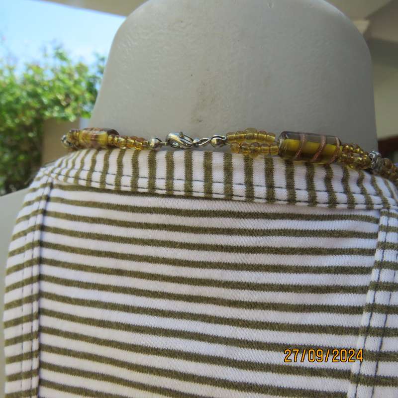 Casual strappy top in horizontal olivegreen-cream stripes. Size 38.Pretty back. Used but in good con