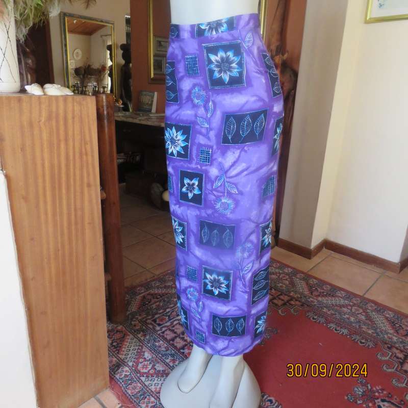 Sleek viscose ankle length viscose skirt in eyecatching purple black and blue pattern.Size 32.As new