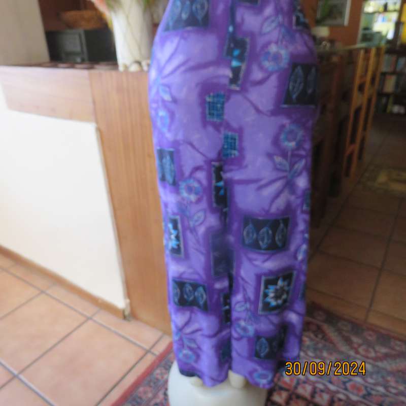 Sleek viscose ankle length viscose skirt in eyecatching purple black and blue pattern.Size 32.As new