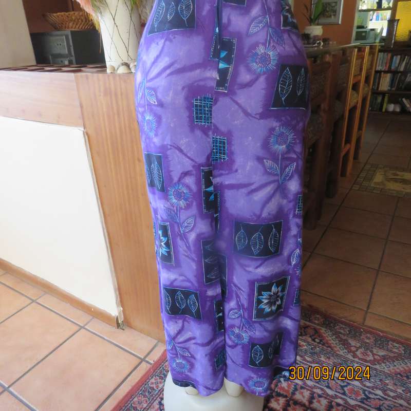 Sleek viscose ankle length viscose skirt in eyecatching purple black and blue pattern.Size 32.As new