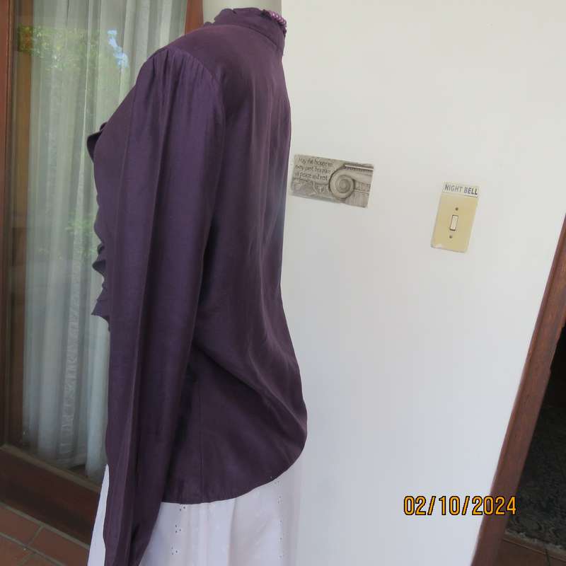 Smart shiny dark purple long sleeve tailored top size 34. V front with banded neckline.As new cond.