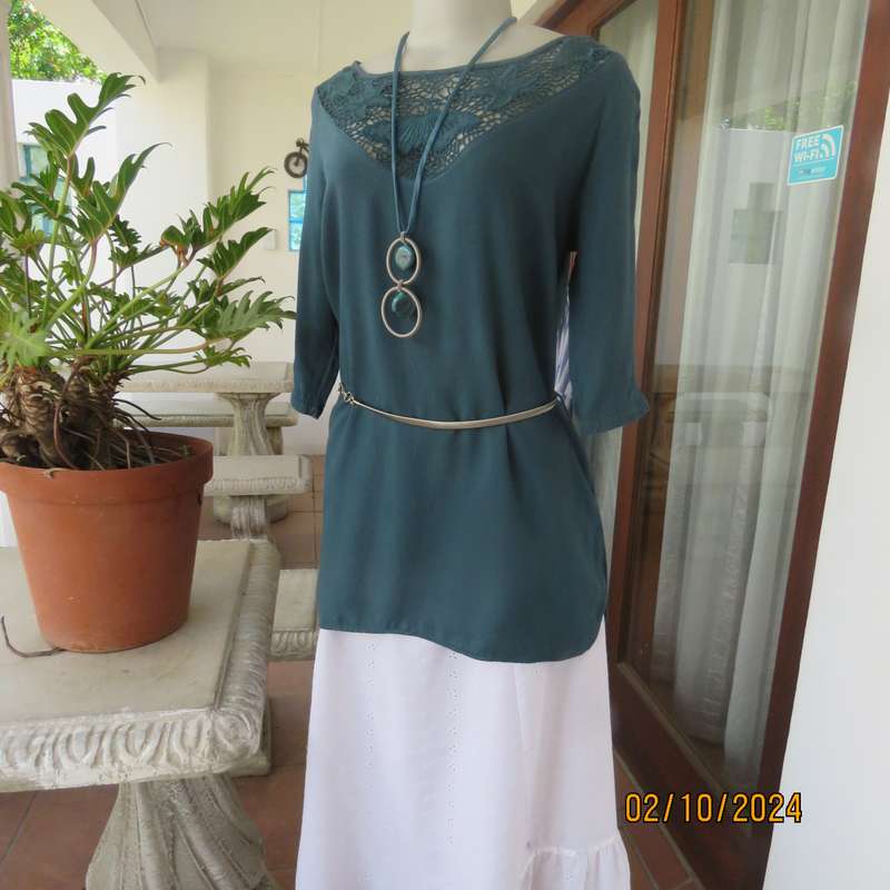 Dark jade long top with elbow length sleeves and round lace inlay neckline. Size 34.In viscose.