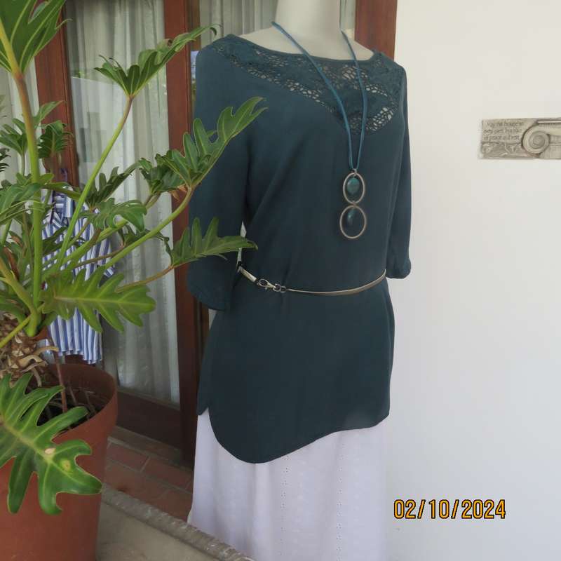 Dark jade long top with elbow length sleeves and round lace inlay neckline. Size 34.In viscose.