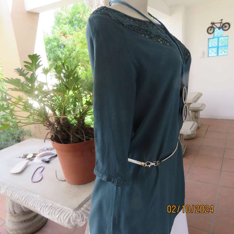 Dark jade long top with elbow length sleeves and round lace inlay neckline. Size 34.In viscose.