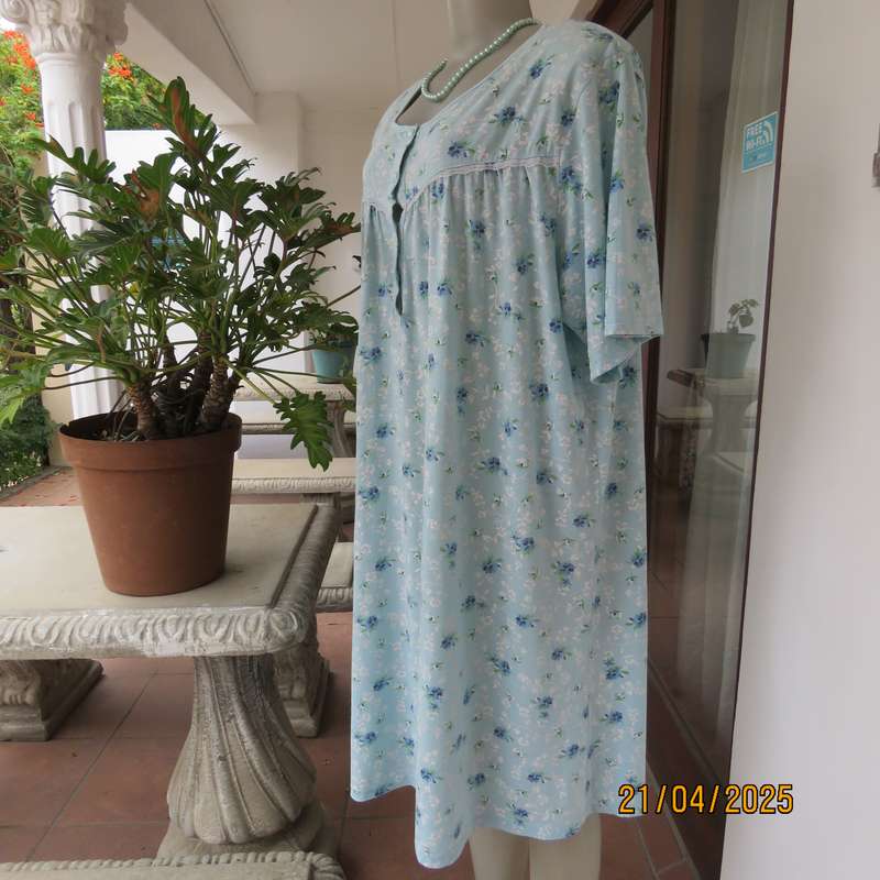 Pale turquoise with tiny blue-white floral pattern nighty. Opening on front. Size 44-46