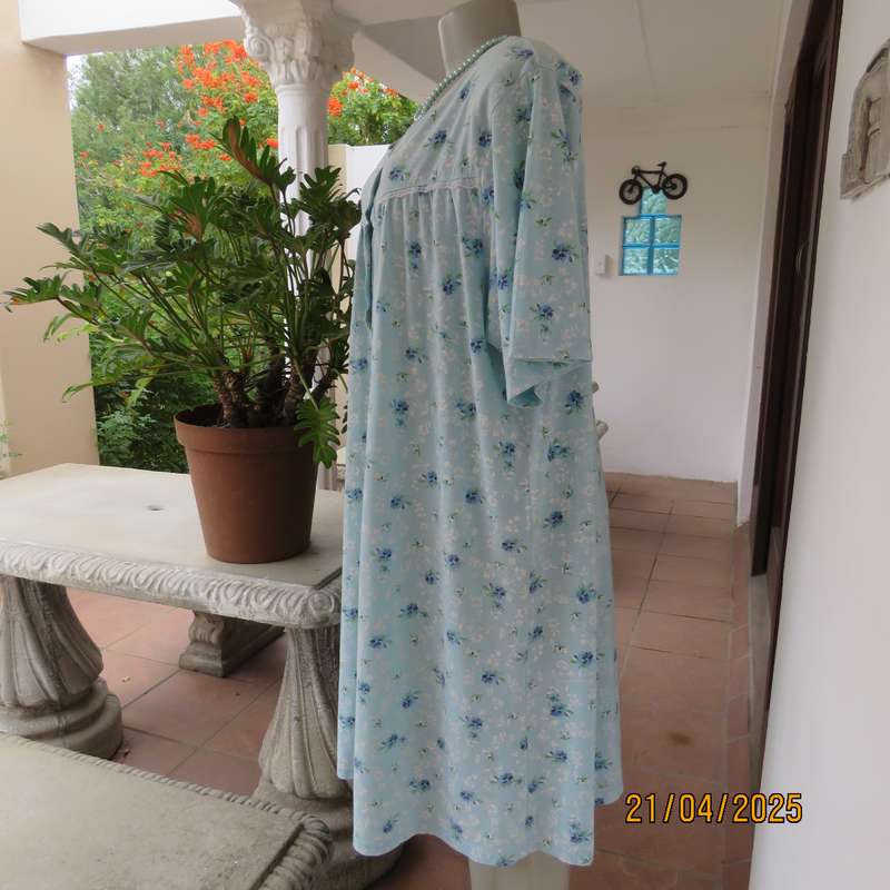 Pale turquoise with tiny blue-white floral pattern nighty. Opening on front. Size 44-46