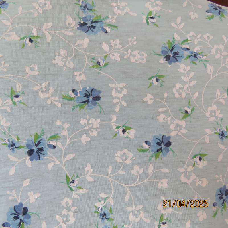 Pale turquoise with tiny blue-white floral pattern nighty. Opening on front. Size 44-46