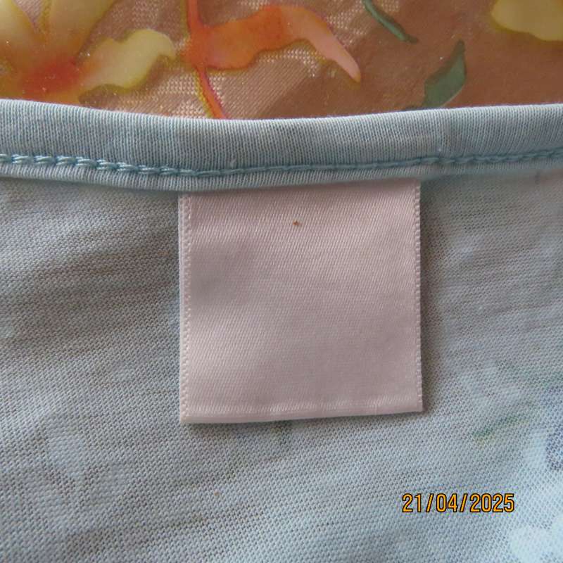 Pale turquoise with tiny blue-white floral pattern nighty. Opening on front. Size 44-46