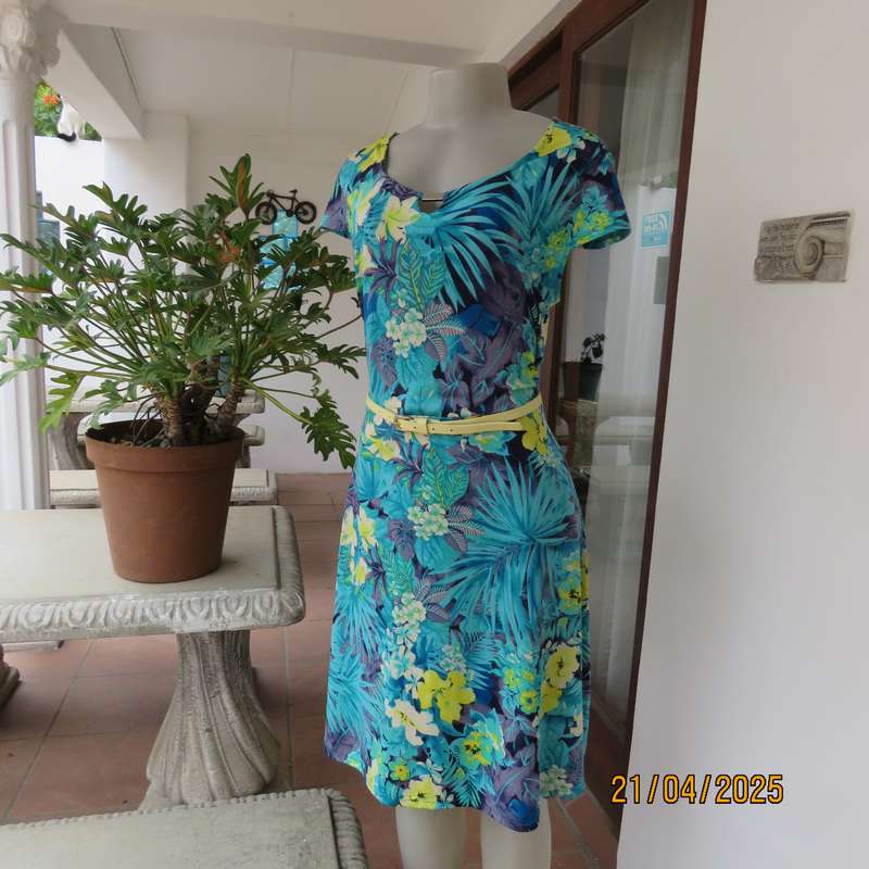 Turquoise-blue patterned stretch polyester slip over size 40 dress with yellow flowers.