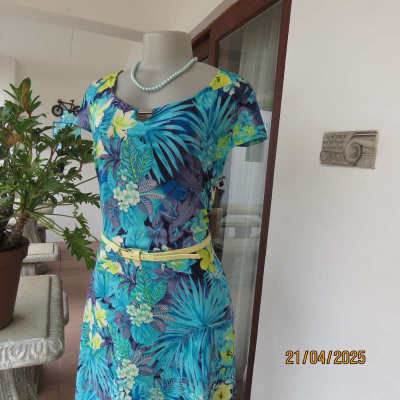 Turquoise-blue patterned stretch polyester slip over size 40 dress with yellow flowers.
