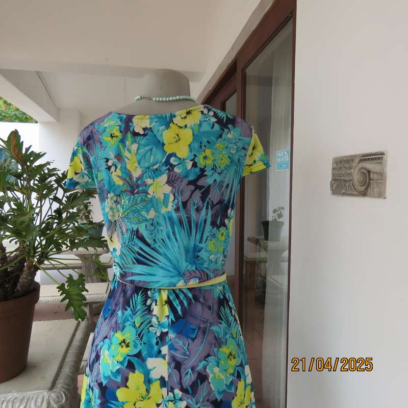 Turquoise-blue patterned stretch polyester slip over size 40 dress with yellow flowers.