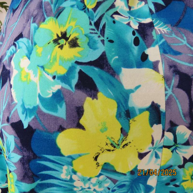 Turquoise-blue patterned stretch polyester slip over size 40 dress with yellow flowers.
