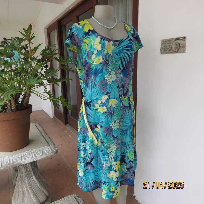 Turquoise-blue patterned stretch polyester slip over size 40 dress with yellow flowers.